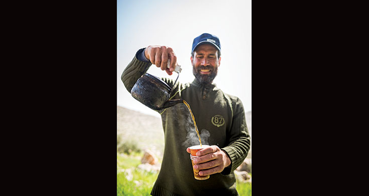 Guide Nedal Sawalmeh pours trailside tea. Photo by Frits Meyst/API